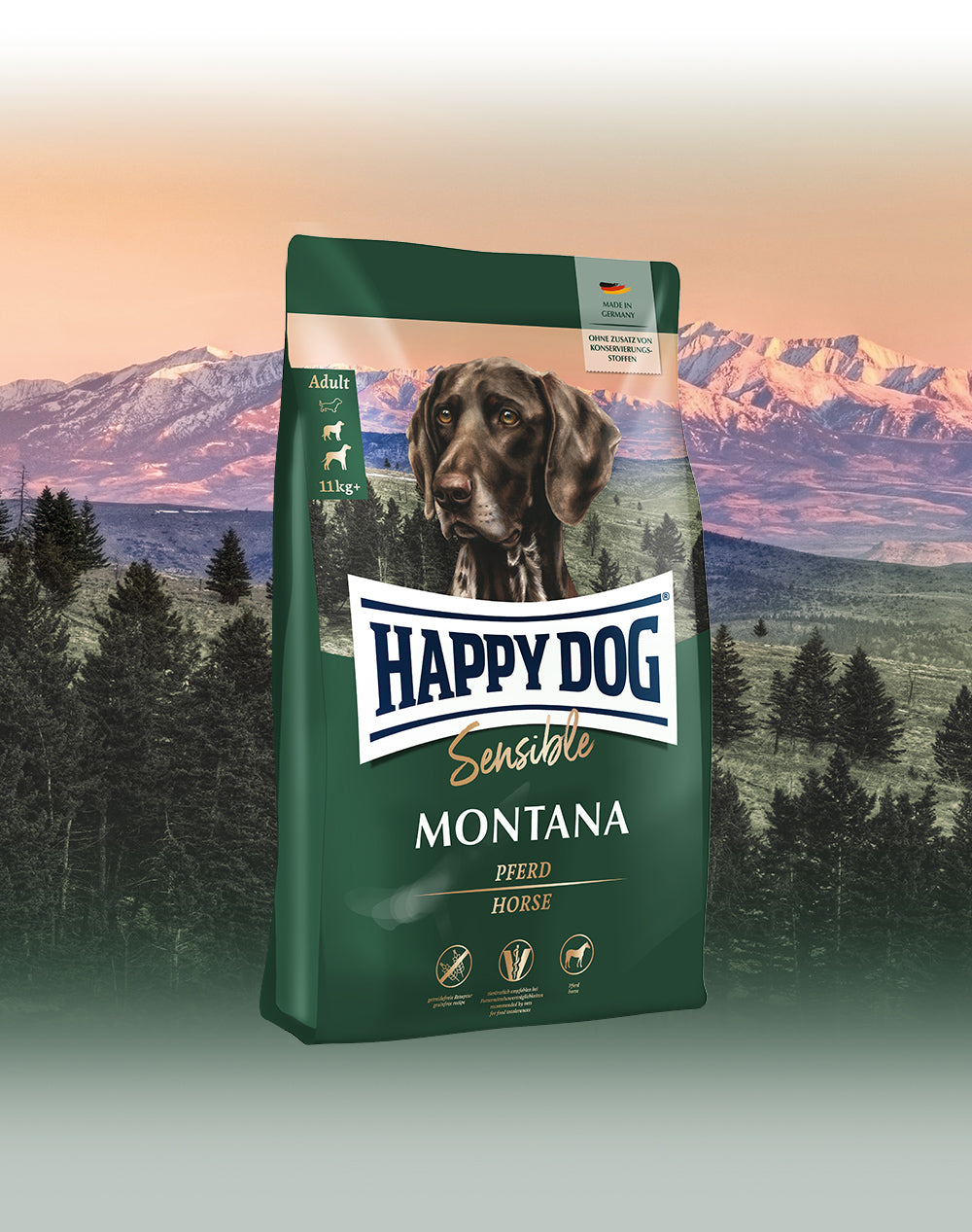 Das Hundefutter Happy Dog Sensible Montana vor einer wilden Berglandschaft bei Sonnenuntergang.