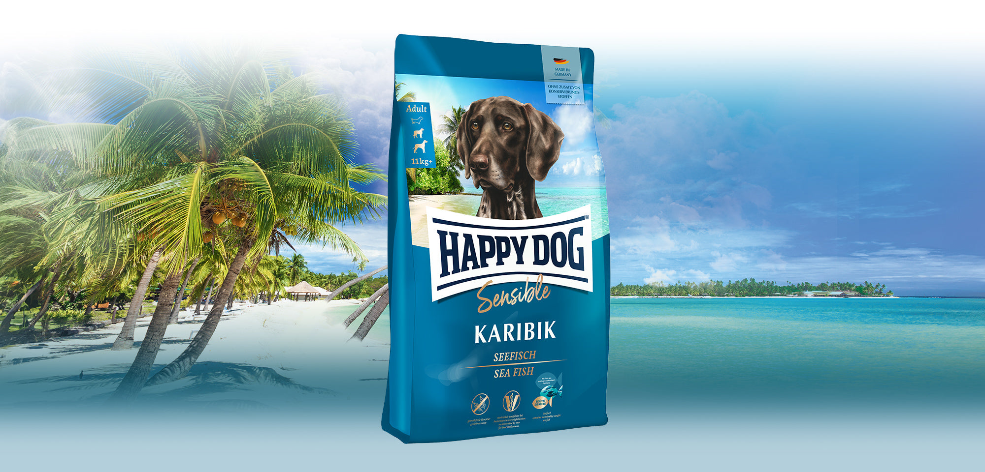 Das Hundefutter Happy Dog Sensible Karibik vor einem karibischen Sandstrand mit Palmen.