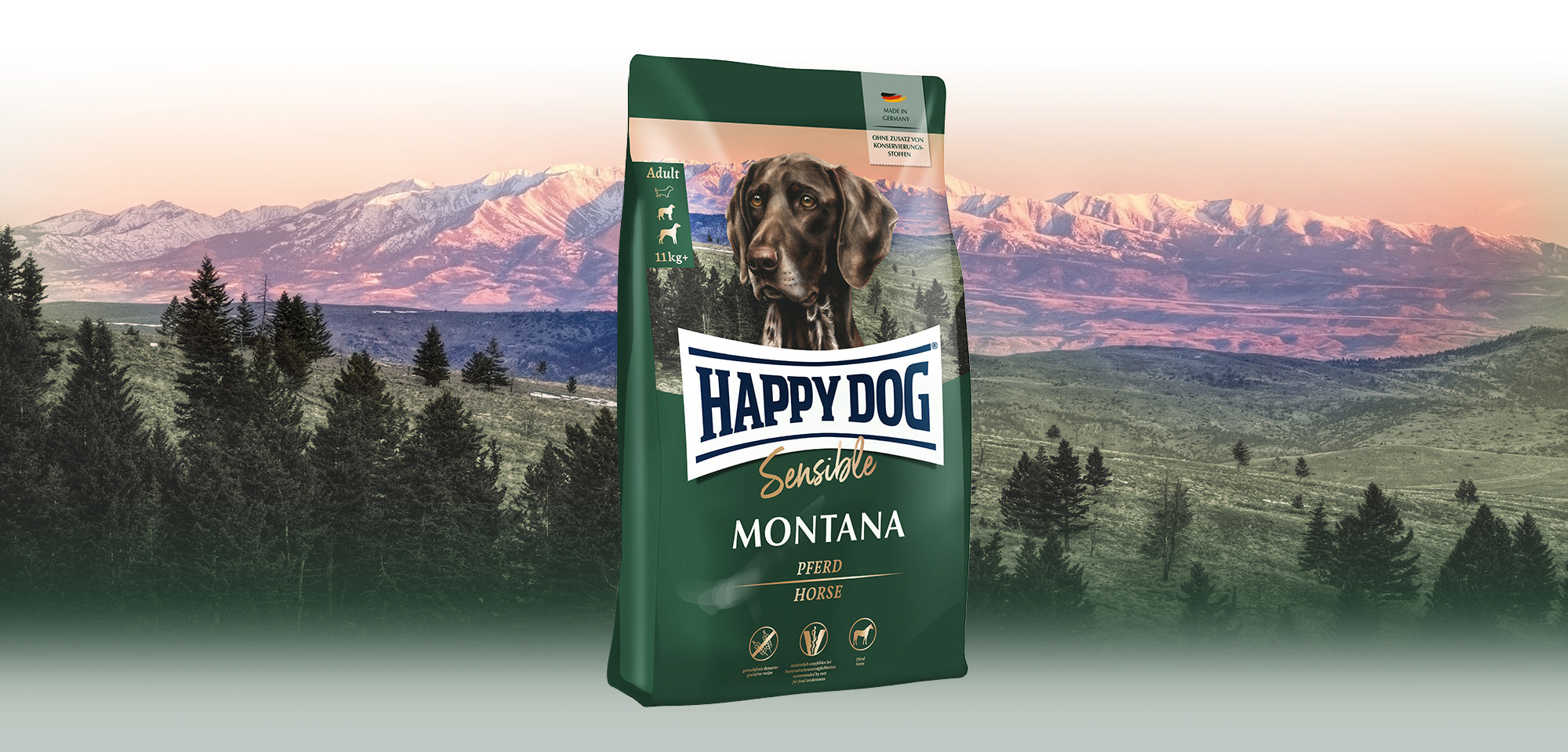 Das Hundefutter Happy Dog Sensible Montana vor einer wilden Berglandschaft bei Sonnenuntergang.